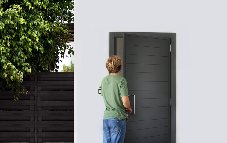 Man opening the door of her home.Inviting the guests